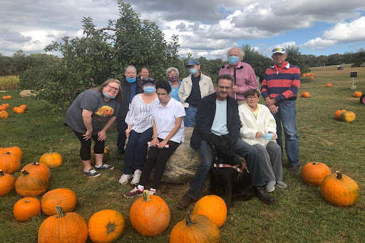 Members and volunteers pick pumpkins for a fundraiser