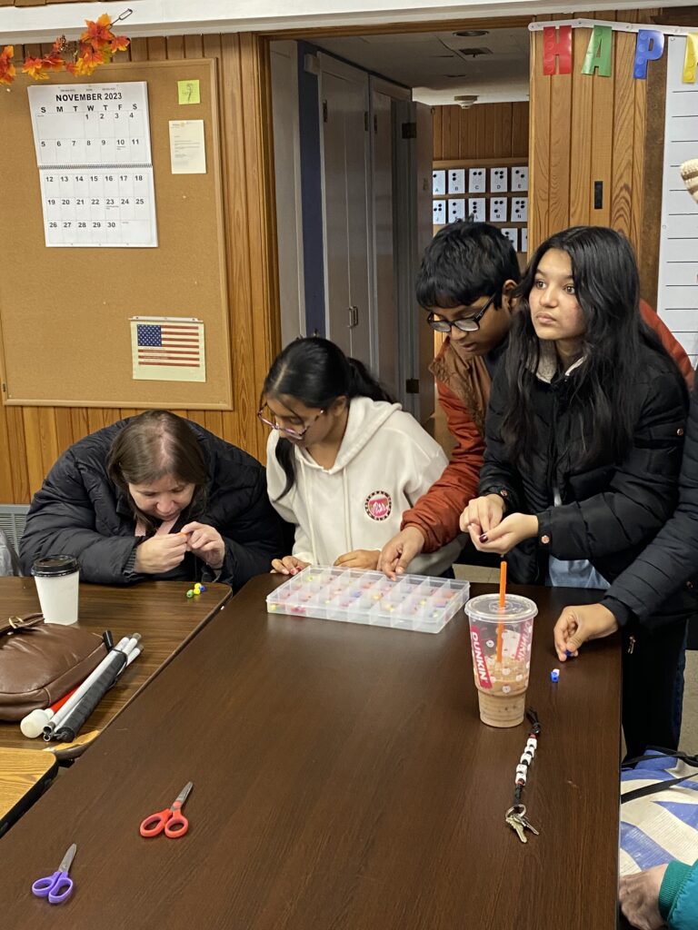 Students attempting to read the braille beads